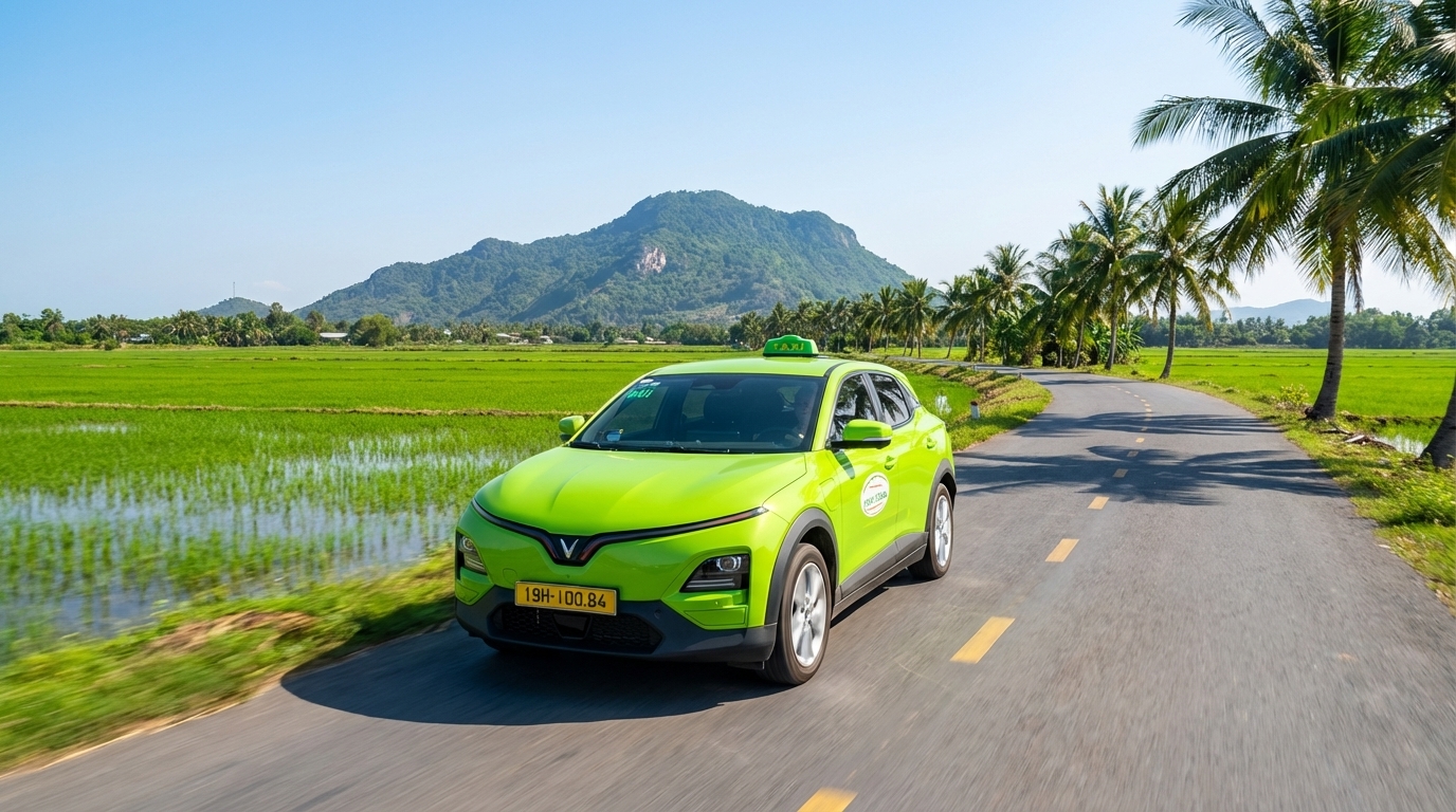 Taxi VinFast VF6 màu xanh cốm trên đường đi Châu Đốc với núi Sam phía xa